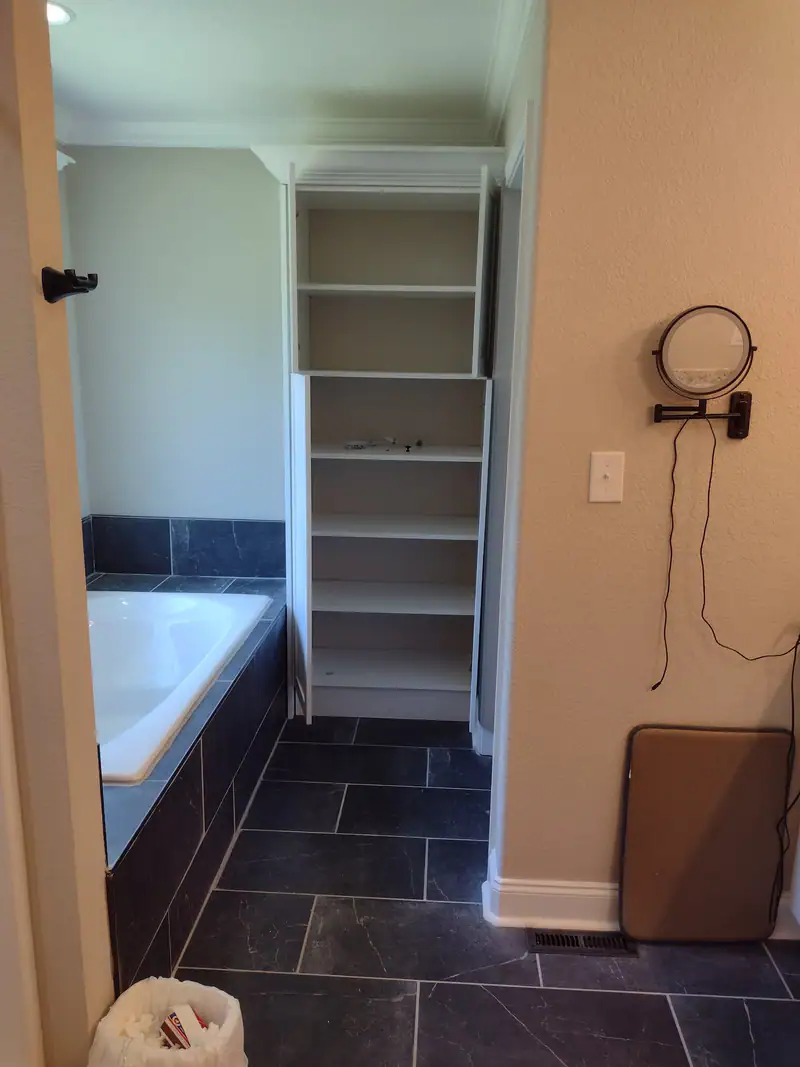 Open shelving built into a bathroom nook