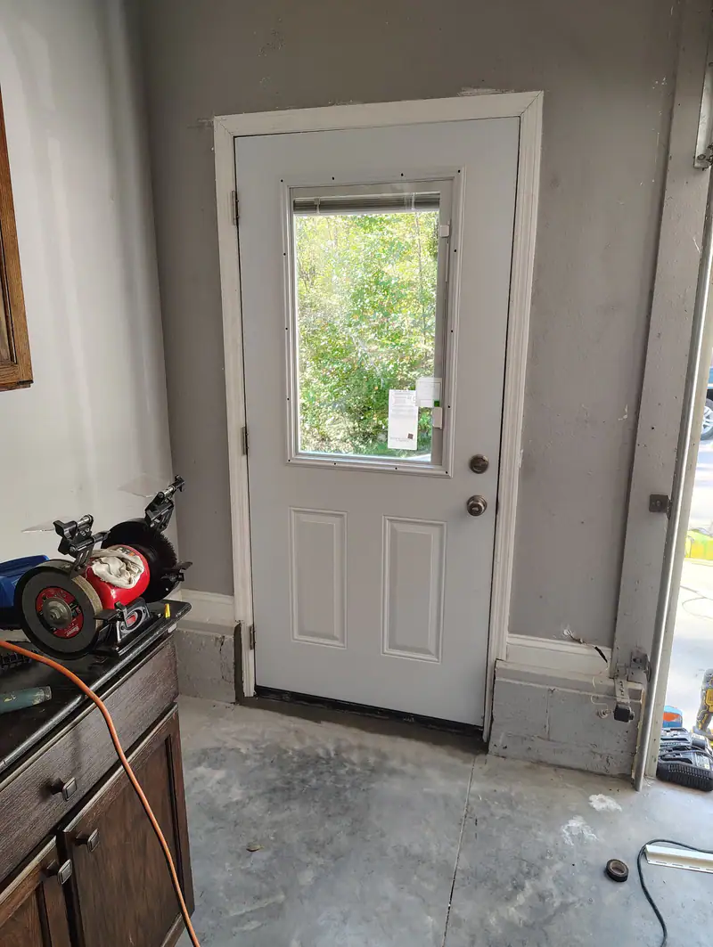 New half-glass entry door between a house and its garage