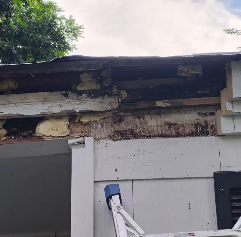 Rotted fascia and soffit opened up on a porch, before the repair