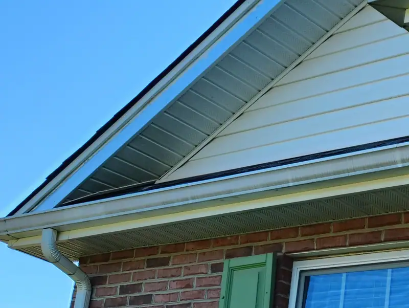 Gable trim, soffit and gutter on a brick house