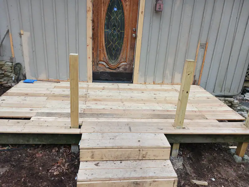 New wood landing and steps built at a front door