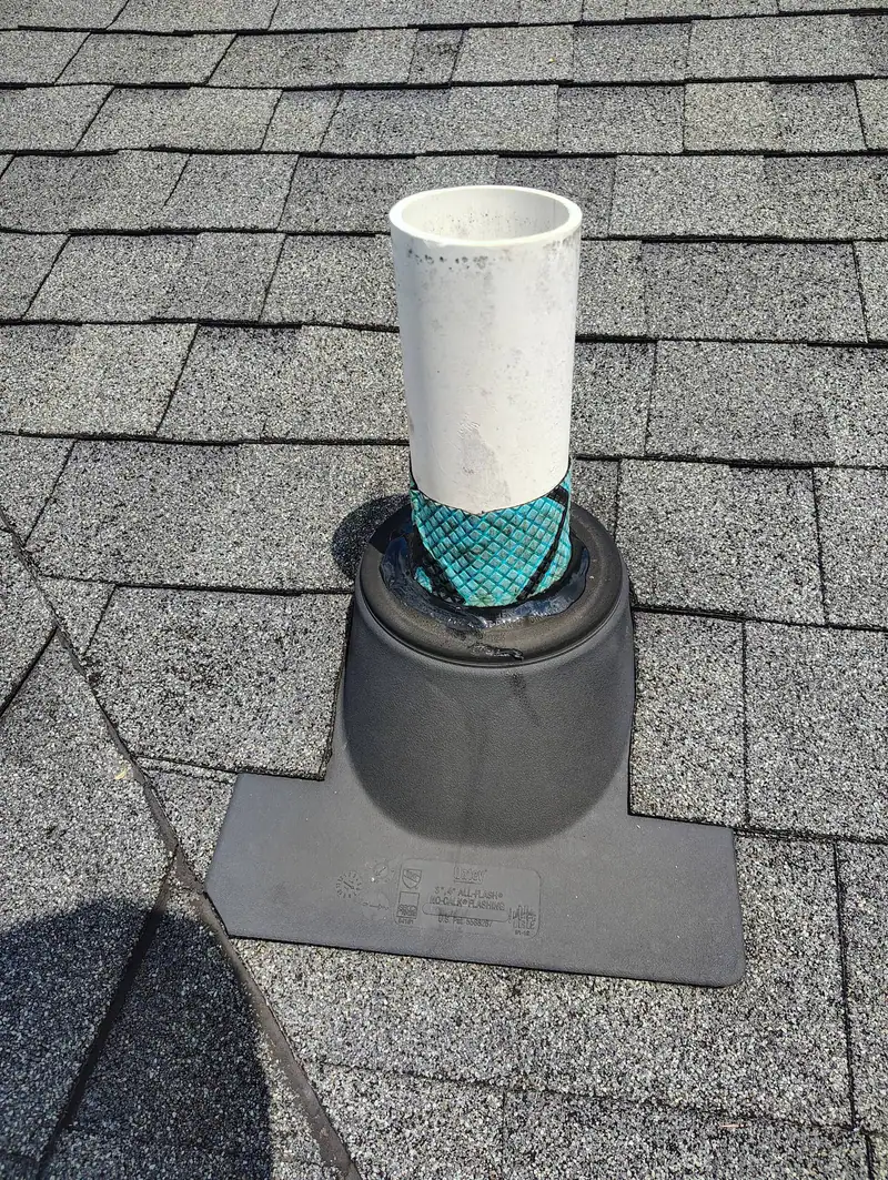 New pipe boot sealed around a vent on a shingle roof