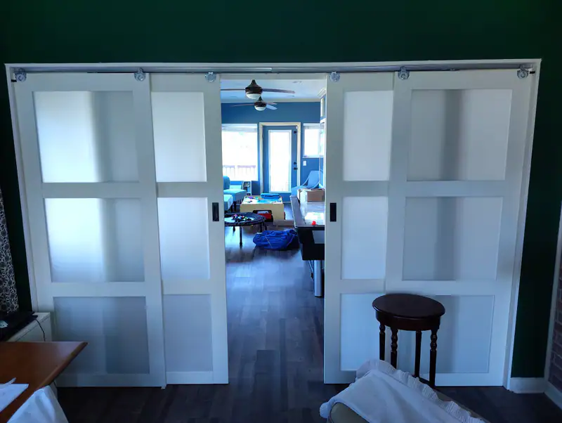 Frosted-glass sliding doors opening into a finished room