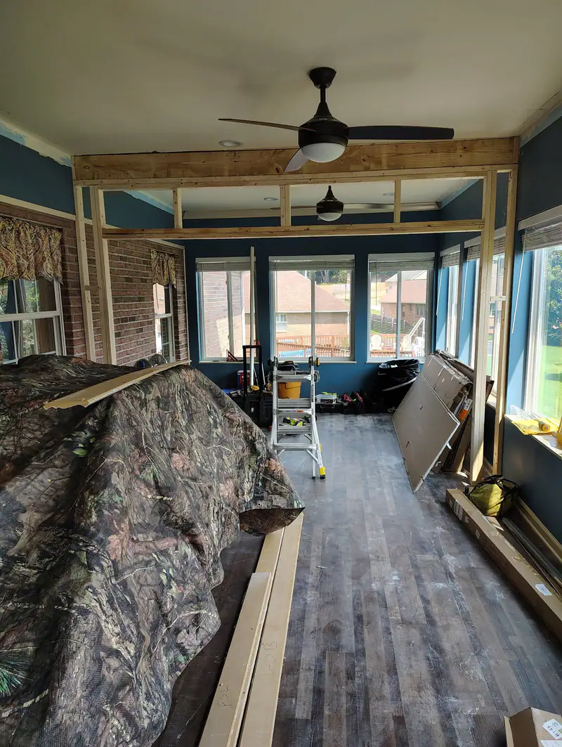 New plank flooring and ceiling framing going into a sunroom