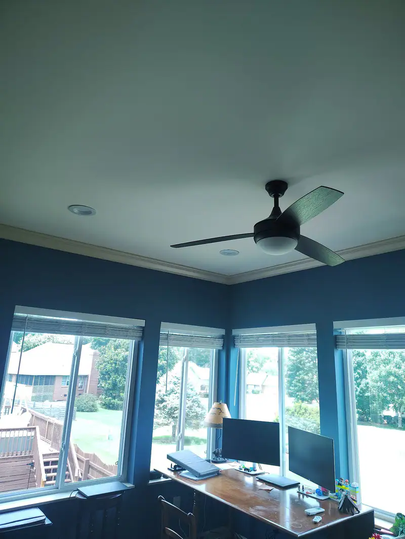 Sunroom with a new ceiling, a ceiling fan and blue walls