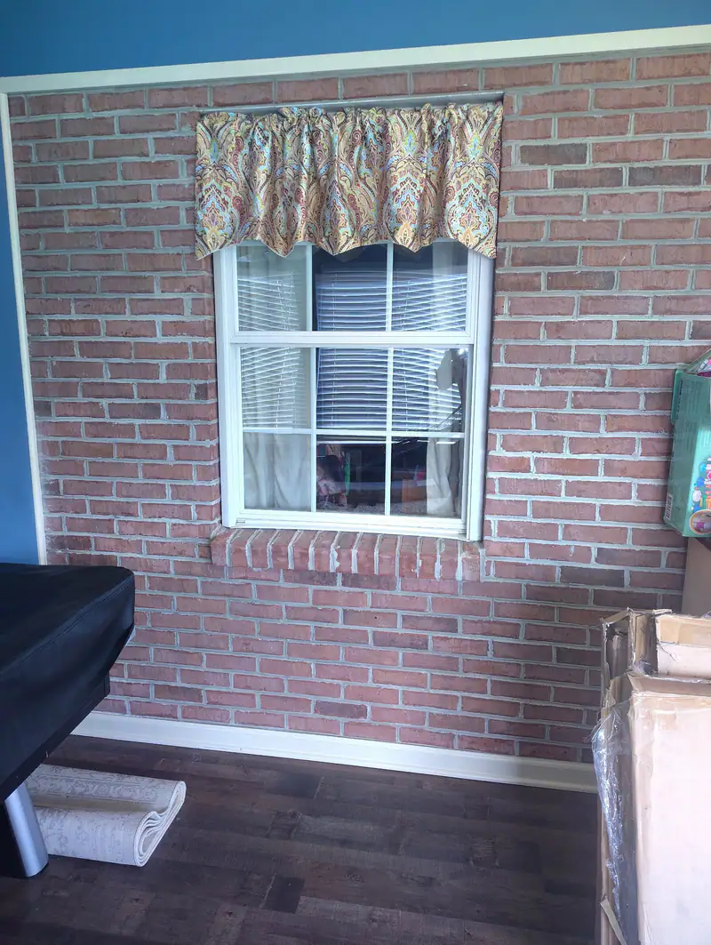 Finished window with new trim in a brick wall
