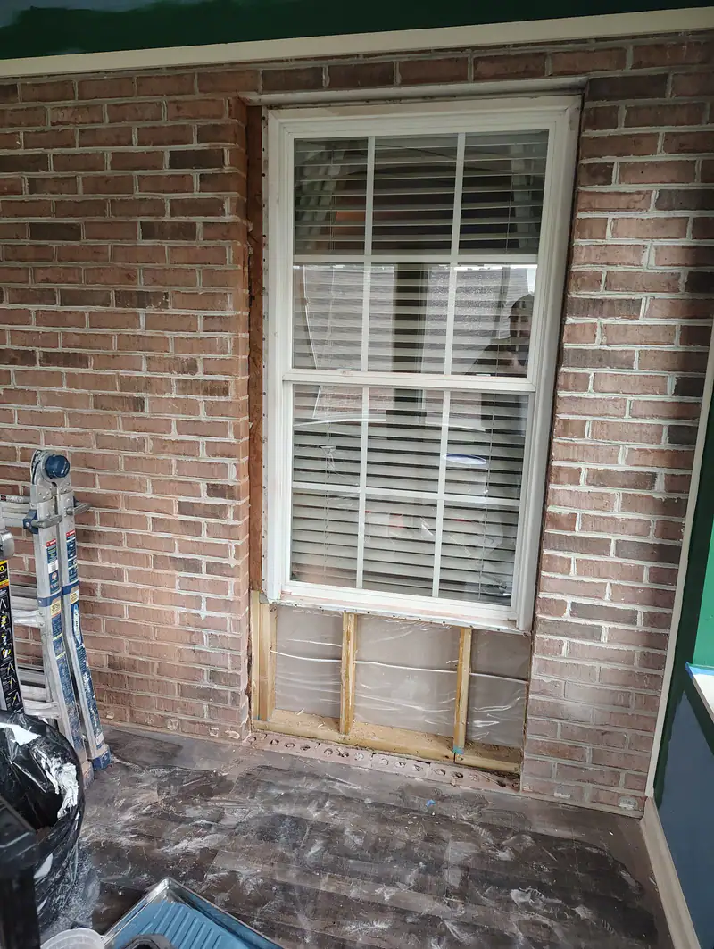 Window opening in a brick wall during reframing